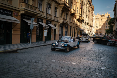 Prague, Czechia - 10.08.2019. The architecture of the old city of Prague. Ancient buildings, cozy streets. Vintage sightseeing tour car waiting for tourists in old townのeditorial素材
