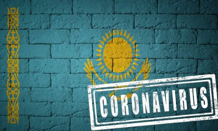 Flag of the Kazakhstan with original proportions. stamped of Coronavirus. brick wall texture. Corona virus concept. On the verge of a COVID-19 or 2019-nCoV Pandemic.の写真素材