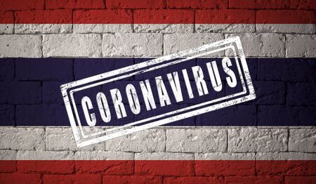 Flag of the Thailand with original proportions. stamped of Coronavirus. brick wall texture. Corona virus concept. On the verge of a COVID-19 or 2019-nCoV Pandemic.の写真素材