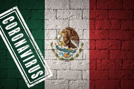 Flag of the Mexico with original proportions. stamped of Coronavirus. brick wall texture. Corona virus concept. On the verge of a COVID-19 or 2019-nCoV Pandemic.の写真素材
