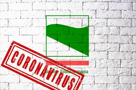 Flag of the regions of Italy Emilia Romagna with original proportions. stamped of Coronavirus. brick wall texture. Corona virus concept. On the verge of a COVID-19 or 2019-nCoV Pandemic.の写真素材