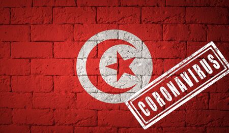 Flag of the Tunisia with original proportions. stamped of Coronavirus. brick wall texture. Corona virus concept. On the verge of a COVID-19 or 2019-nCoV Pandemic.の写真素材