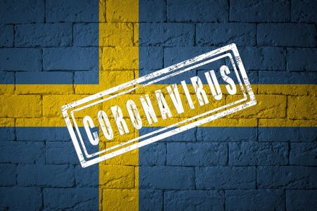 Flag of the Sweden with original proportions. stamped of Coronavirus. brick wall texture. Corona virus concept. On the verge of a COVID-19 or 2019-nCoV Pandemic.の写真素材