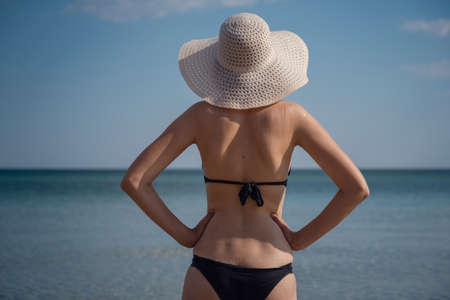 Beautiful Young Woman At Beach Wearing Hat. summer holidays, vacation, travel and people conceptの写真素材