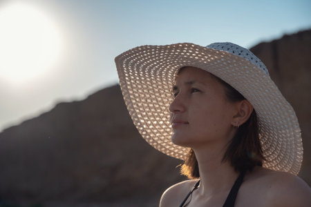 Beautiful Young Woman At Beach Wearing Hat. summer holidays, vacation, travel and people conceptの写真素材