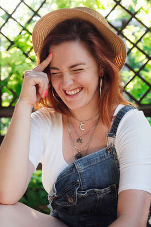 Happy young woman portrait, summer outdoors. beautiful garden in the sunsetの写真素材