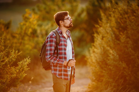 Man hiking at sunset mountains with backpack. Travel Lifestyle wanderlust adventure concept summer...