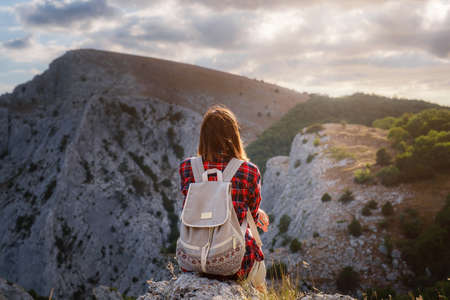 woman hiker enjoy the view at sunset mountain peak cliff. idea of ecotourism travel. Discovery Travel Destination Conceptの写真素材