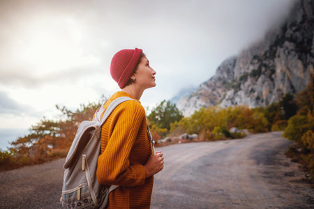 Outdoor fashion photo of young beautiful asian lady surrounded autumn forest in mountains. Portrait...