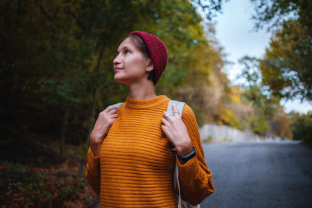 Outdoor fashion photo of young beautiful asian lady surrounded autumn forest in mountains. Portrait...