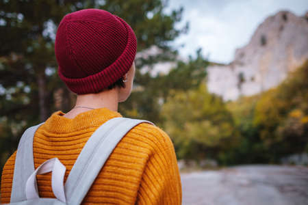 Outdoor fashion photo of young beautiful asian lady surrounded autumn forest in mountains. Portrait of romantic hipster female, Warm autumn weather, calm scene. Wanderlust photo series.の写真素材