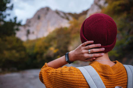 Outdoor fashion photo of young beautiful asian lady surrounded autumn forest in mountains. Portrait of romantic hipster female, Warm autumn weather, calm scene. Wanderlust photo series.の写真素材