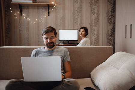 Couple Working And Playing With Laptop Computer At Home.の写真素材