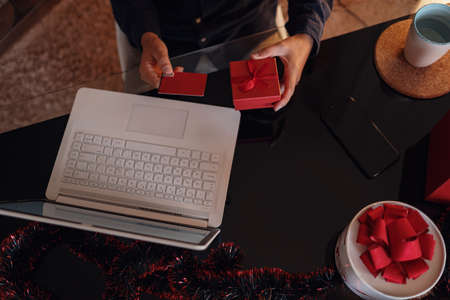 Happy man wearing Santa Claus hat. Buying christmas gifts online - online shopping concept. Ecommerce website xmas time holiday online shopping sale.の写真素材
