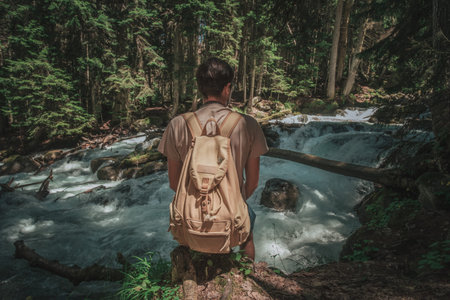 Feet Man hiking outdoor with river and forest on background Lifestyle Travel survival concept