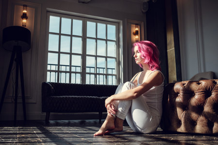 Lovely young woman posing in photo studio with natural light. Young and sexyの写真素材