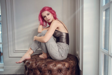 Lovely young woman posing in photo studio with natural light. Young and sexy