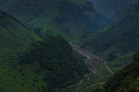 Caucasian Mountain ranges and valleys at Gudauri, Georgia. Summer day on the military-Georgian road. Rapid weather change in the mountainsの写真素材