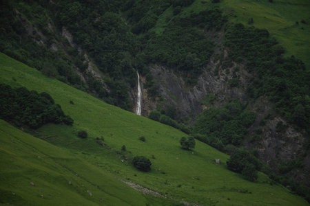 Caucasian Mountain ranges and valleys at Gudauri, Georgia. Summer day on the military-Georgian road. Rapid weather change in the mountainsの写真素材