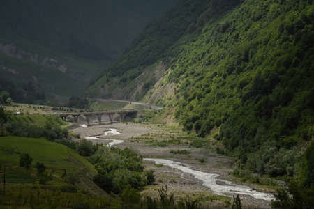Caucasian Mountain ranges and valleys at Gudauri, Georgia. Summer day on the military-Georgian road. Rapid weather change in the mountainsの写真素材