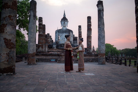 Sukhothai, Thailand - April, 9,2017: Beautiful Thai women in traditional costume of Thailand at Temple in Sukhothai Historical Park, Thailand.のeditorial素材