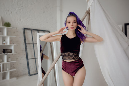 pretty vigorous athletic cheerful girl in pajamas bright sing and rejoice after sleeping, playing...