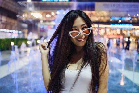 Young beautiful asian girl in big mall, bangkok. Stylish shopping trip