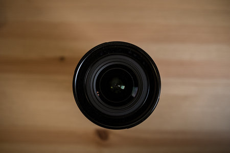 MOSCOW, RUSSIA - 17 MARCH 2019: Fuji LENS. the camera lens on light wooden table, Top view. Flat lay style. Close up.のeditorial素材