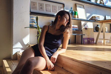 Model with perfect sensual figure pose in home interior. Sexy lady in classic room with sunny light....