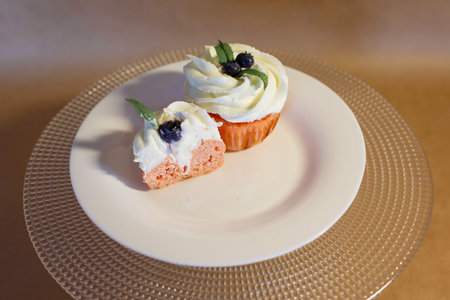 cupcakes with blueberries and blueberries on a plate. Cupcakes for happy valentine's day. Home-made vanilla muffins with fresh berries on a stand.の写真素材