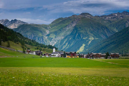Swiss village in the Alps, Switzerland, Europe. Gloomy landscape without sunlightの写真素材