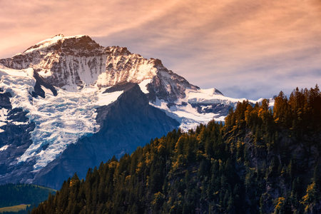 Alpine snow peak against a gloomy sky. Dolomites, Italy, spring in the mountains. The concept and...