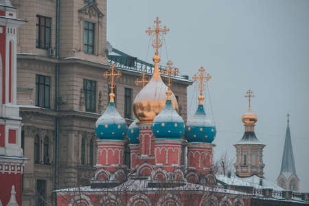 Winter in Red Square, heavy snow clouds. Christmas fair in Kremlin of Russia at evening while snow fallingの写真素材