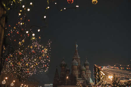 Christmas fair in Moscow at evening while snow. Red Square and St. Basil's Cathedralの写真素材