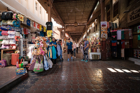 Dubai, United Arab Emirates - March 6, 2017: Shops and vendors in the ancient covered textile souq Bur Dubai in the old city center. The traditional Arab style bazaarのeditorial素材