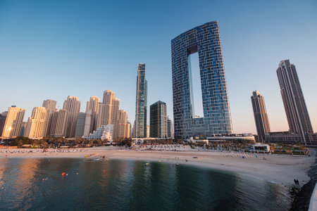 Dubai, UAE - February 15, 2020: Marina JBR Beach Sea water font tall buildings. Urban Arabian Architectural Excellence. dubai marina captured from the Ain Dubai in Blue water islandsのeditorial素材