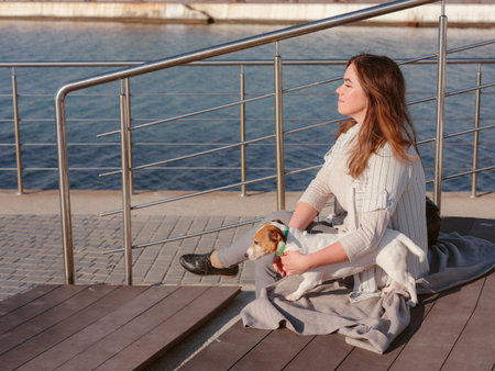 Young woman with her cute Jack Russell Terrier outdoor. Lovely pet. A woman and her faithful pet...