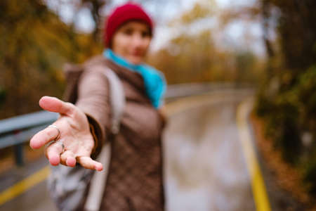 beautiful female hipster walks in the autumn nature. Cool weather. Wanderlust photo series.の写真素材