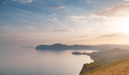 Stunning scenery in the sunset rays of the sea coast and mountains. Black Sea coast, view of Koktebel, massif Karadagの写真素材