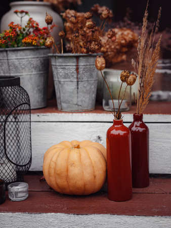 Autumn wooden porch or patio, family heirlooms, with pumpkins and cozy blankets. thanksgiving landscaping decor.の写真素材