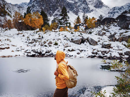 Hiker enjoying view at Orlenok Lake during autumn in North Caucasus, Arkhyz, Karachay-Cherkessia, Russia. concept of travel and active lifestyleの写真素材