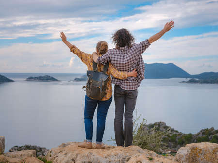 Couple traveler explore ruins castle of Simena with view of sea bay and Kekova Island with famous flooded city. Tourist attractions in Turkey.の写真素材