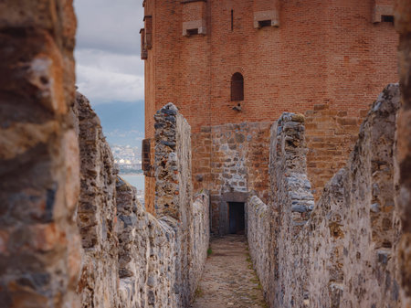 Alanya, turkey, winter walk by mediterranean sea. Kizil Kule tower on peninsula of Alanya. Famous tourist destination with high mountains. Part of ancient old castle.の写真素材