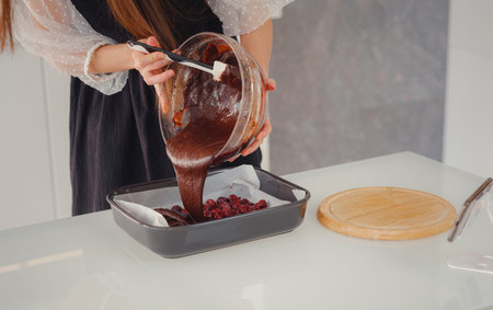 bakery, food and people concept. Woman preparing chocolate brownie at kitchen table, closeup. Woman...