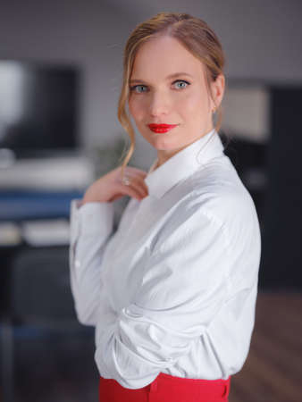 business woman working in office. Online business, young professional in the workplace. Portrait of attractive cheerful lady hr leader director real estate agency broker at work place station indoorsの写真素材