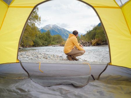 trip to Caucasus mountains, Arkhyz, Teberdinsky reserve. Man traveler relaxing mountains and river in tent camping outdoor Travel adventure lifestyle concept hiking active vacations.の写真素材