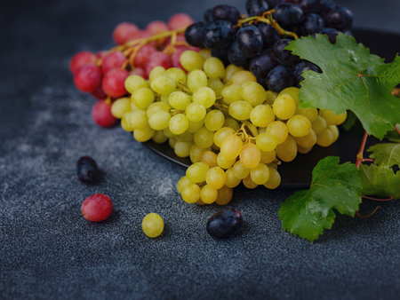 Vineyard harvest in autumn season. Crop and juice, Organic blue, red and green grapes on table viewed from above, concept wineの写真素材