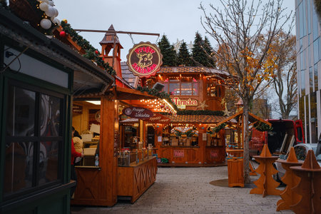Dusseldorf. GERMANY. 13 DECEMBER 2022. The Christmas in Germany. Christmas market spirit. Celebrating Xmas holidays. Lights, carousel, small houses at market in city center with amazing food selectionのeditorial素材