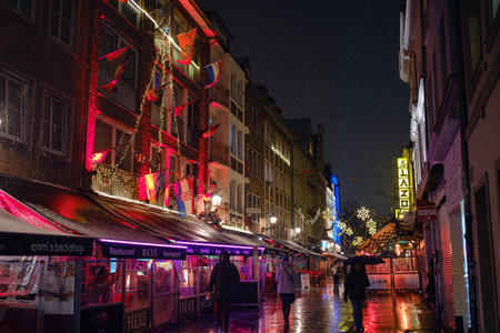 Dusseldorf. GERMANY. 13 DECEMBER 2022. The Christmas in Germany. Christmas market spirit. Celebrating Xmas holidays. Lights, carousel, small houses at market in city center with amazing food selectionのeditorial素材