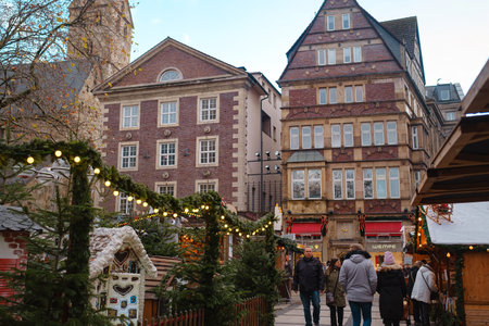 Dortmund. GERMANY. 13 DECEMBER 2022. The Christmas market spirit. Celebrating Xmas holidays. Lights, carousel, small houses at market in city center with amazing food selection.のeditorial素材